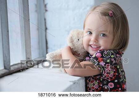 a young girl hugs her teddy bear View Large Photo Image Stock Photograph - a young girl hugs her teddy bear. Fotosearch