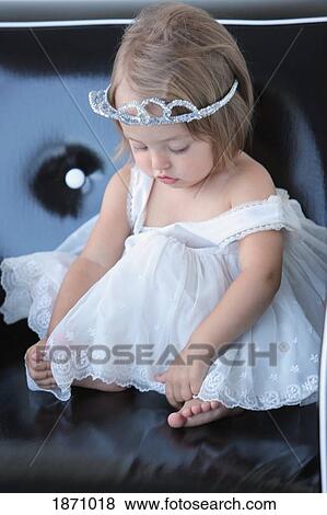 a young girl in a white dress wearing a tiara View Large Photo Image Stock Photo - a young girl in a white dress wearing a tiara. Fotosearch