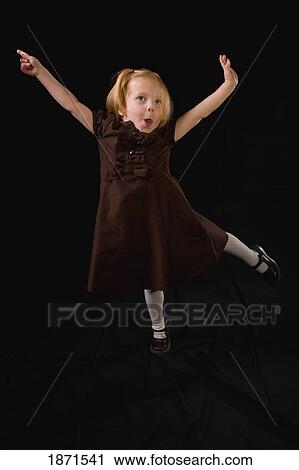 a young girl jumping in the air View Large Photo Image Stock Image - a young girl jumping in the air. Fotosearch