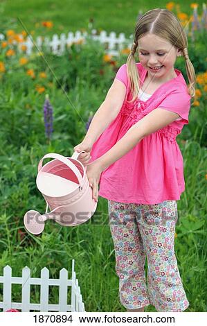 Picture - a young girl watering the flower garden. Fotosearch