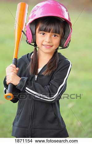 Picture - a young girl wearing a helmet and holding a baseball bat. Fotosearch