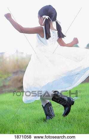 a young girl wearing a white dress and cowboy boots View Large Photo Image Stock Photo - a young girl wearing a white dress and cowboy boots. Fotosearch