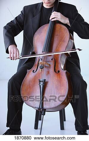 a young man playing a cello View Large Photo Image Stock Image - a young man playing a cello. Fotosearch