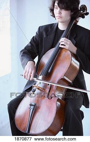 a young man playing a cello View Large Photo Image Stock Photo - a young man playing a cello. Fotosearch