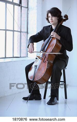 a young man playing a cello View Large Photo Image Stock Photograph - a young man playing a cello. Fotosearch