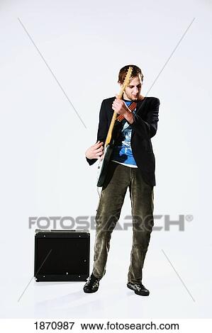 a young man playing an electric guitar View Large Photo Image Stock Photo - a young man playing an electric guitar. Fotosearch