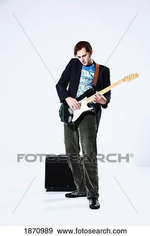 a young man playing an electric guitar View Large Photo Image Stock Photo - a young man playing an electric guitar. Fotosearch