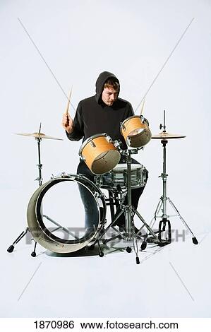 Stock Photograph - a young man playing the drums. Fotosearch