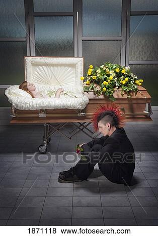 a young man sitting beside a coffin with a young woman's body in it View Large Photo Image Stock Photo - a young man sitting beside a coffin with a young woman's body in it. Fotosearch