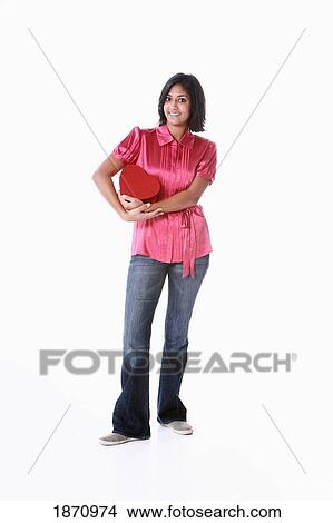 a young woman holding a heart in her arms View Large Photo Image Picture - a young woman holding a heart in her arms. Fotosearch