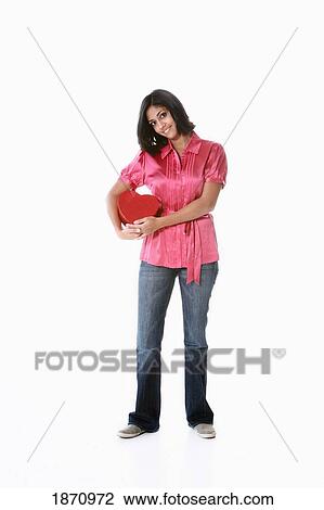 a young woman holding a heart in her arms View Large Photo Image Stock Image - a young woman holding a heart in her arms. Fotosearch