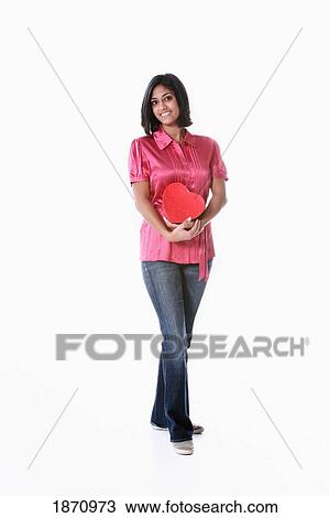 a young woman holding a heart in her arms View Large Photo Image Stock Image - a young woman holding a heart in her arms. Fotosearch
