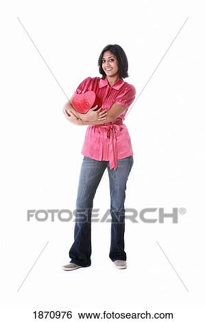 a young woman holding a heart in her arms View Large Photo Image Stock Photograph - a young woman holding a heart in her arms. Fotosearch