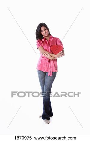 a young woman holding a heart in her arms View Large Photo Image Stock Photography - a young woman holding a heart in her arms. Fotosearch