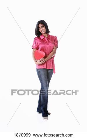 a young woman holding a heart View Large Photo Image Stock Photo - a young woman holding a heart. Fotosearch