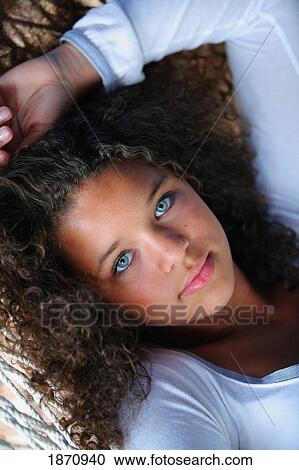 a young woman laying on a hammock View Large Photo Image Stock Image - a young woman laying on a hammock. Fotosearch