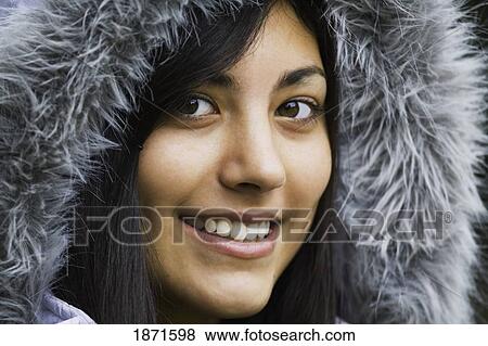 a young woman wearing a fur trimmed hood View Large Photo Image Stock Photo - a young woman wearing a fur trimmed hood. Fotosearch