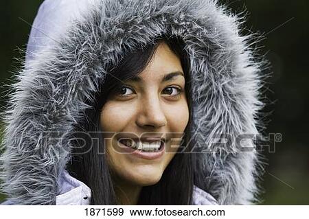 a young woman wearing a fur trimmed hood View Large Photo Image Stock Photo - a young woman wearing a fur trimmed hood. Fotosearch