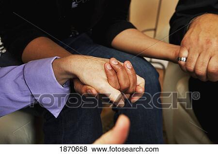 Stock Photo - adults holding hands. Fotosearch