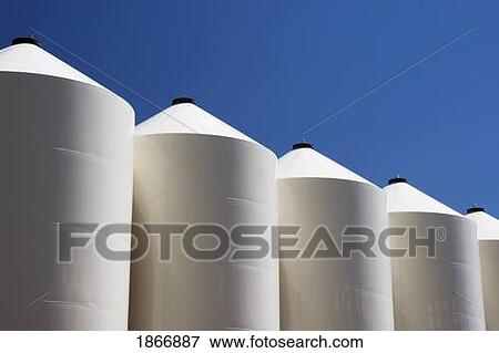 Stock Photo - alberta, canada; large white metal grain bins. Fotosearch
