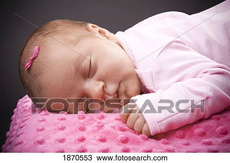 an infant girl laying on a pink blanket View Large Photo Image Stock Image - an infant girl laying on a pink blanket. Fotosearch
