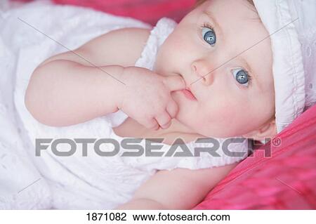 an infant girl wearing a white dress and hat View Large Photo Image Stock Image - an infant girl wearing a white dress and hat. Fotosearch