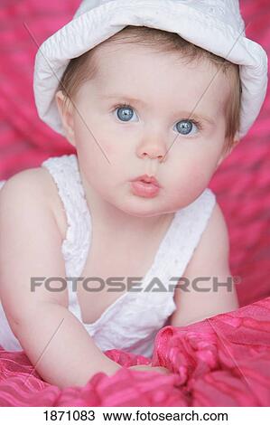 an infant girl wearing a white dress and hat View Large Photo Image Stock Image - an infant girl wearing a white dress and hat. Fotosearch