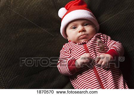 an infant wearing a red and white christmas sleeper with a santa hat View Large Photo Image Stock Image - an infant wearing a red and white christmas sleeper with a santa hat. Fotosearch