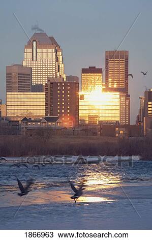 Stock Image - calgary, alberta, canada; bow river and buildings reflecting the sun in winter. Fotosearch