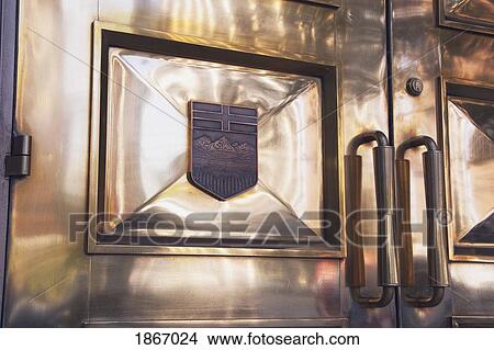 Picture - calgary, alberta, canada; golden doors of the old courthouse with the alberta crest on them. Fotosearch