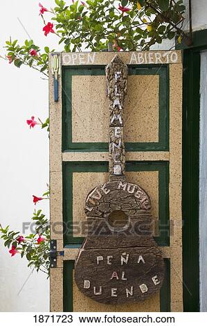 Stock Image - castellar de la frontera, andalusia, spain; a sign in the shape of a guitar saying 'live music'. Fotosearch