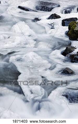Stock Image - columbia river gorge national scenic area, oregon, united states of america; snow and ice covering a creek. Fotosearch