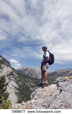 crowsnest pass, alberta, canada; a male hiker standing on a ridge looking at turtle mountain View Large Photo Image Stock Photo - crowsnest pass, alberta, canada; a male hiker standing on a ridge looking at turtle mountain. Fotosearch