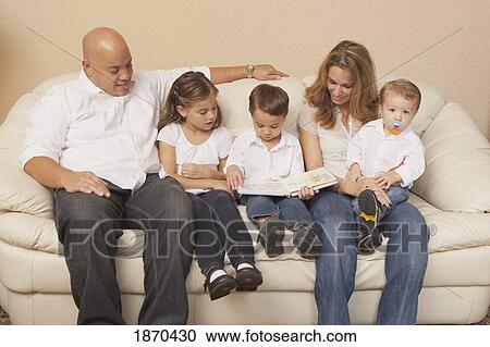 family looking at a book together View Large Photo Image Stock Image - family looking at a book together. Fotosearch