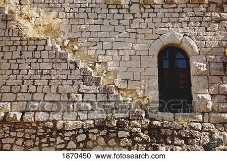 Stock Image - gourdon, provence, france; a door in a stone wall. Fotosearch
