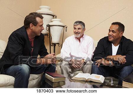 Stock Image - men in a home bible study. Fotosearch