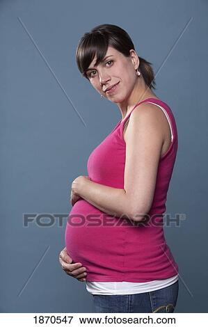 nashville, tennessee, united states of america; a pregnant woman holding her belly View Large Photo Image Stock Photo - nashville, tennessee, united states of america; a pregnant woman holding her belly. Fotosearch