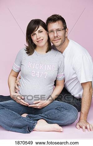 Stock Photo - nashville, tennessee, united states of america; a man and pregnant woman sitting together. Fotosearch