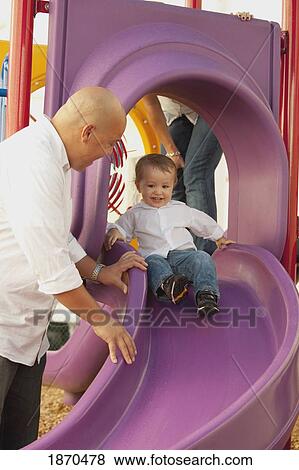 parents at the playground with their young son View Large Photo Image Stock Photo - parents at the playground with their young son. Fotosearch