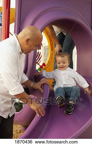 parents playing with young child at the playground View Large Photo Image Stock Photograph - parents playing with young child at the playground. Fotosearch