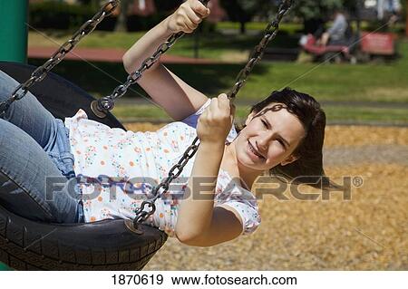 portland, oregon, united states of america; a girl riding a tire swing at the playground View Large Photo Image Stock Photo - portland, oregon, united states of america; a girl riding a tire swing at the playground. Fotosearch