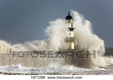 Stock Photograph - seaham, teesside, england; waves crashing into a lighthouse. Fotosearch