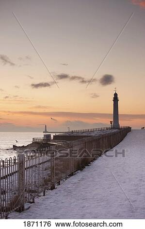 Stock Photograph - sunderland, tyne and wear, england; a lighthouse along the coast in winter. Fotosearch