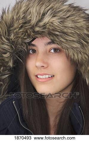 Stock Image - teenage girl wearing a fur trimmed hood. Fotosearch