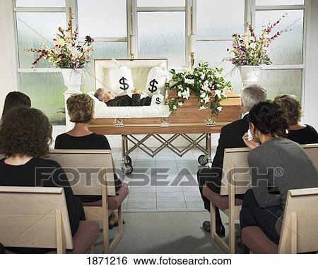 the deceased laying in a coffin at his funeral with bags of money surrounding him View Large Photo Image Stock Photograph - the deceased laying in a coffin at his funeral with bags of money surrounding him. Fotosearch