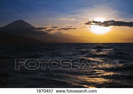 the sun setting over the water View Large Photo Image Stock Photo - the sun setting over the water. Fotosearch