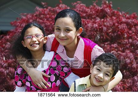 Picture - three children in an embrace. Fotosearch