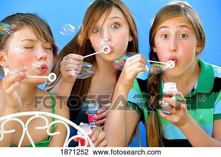 three friends blowing bubbles View Large Photo Image Stock Image - three friends blowing bubbles. Fotosearch