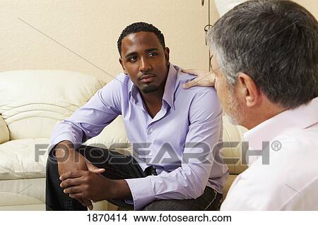 Picture - two men talking. Fotosearch