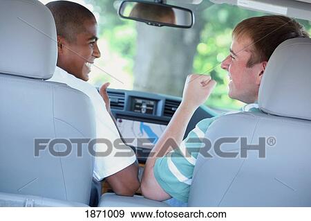 two teenagers in the front seat of the car View Large Photo Image Stock Photo - two teenagers in the front seat of the car. Fotosearch